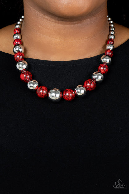 Stone Age Adventurer Red Necklace - Paparazzi Accessories  Featuring a red and black marble finish, a fiery collection of faux stone and classic silver beads gradually increase in size as they alternate below the collar for a statement-making look. Features an adjustable clasp closure.  Sold as one individual necklace. Includes one pair of matching earrings.