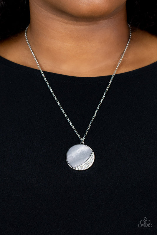 Oceanic Eclipse Silver Necklace - Paparazzi Accessories  An Ultimate Gray shell-like pendant is eclipsed in a half moon silver frame that is encrusted in sparkly white rhinestones, creating a shimmery display below the collar. Features an adjustable clasp closure.  Sold as one individual necklace. Includes one pair of matching earrings.