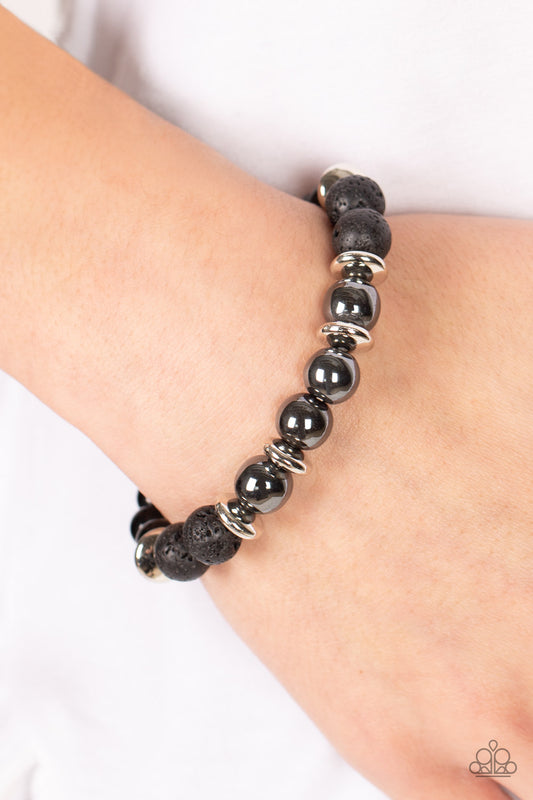 Mega Metamorphic Black Urban Bracelet - Paparazzi Accessories   Infused with a section of polished black beads, a stellar assortment of gunmetal beads, silver accents, and black lava rock beads are threaded along stretchy bands around the wrist for an urban flair.  Sold as one individual bracelet.