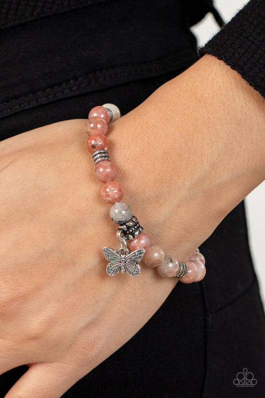 Butterfly Nirvana Pink Bracelet - Paparazzi Accessories  Infused with a silver butterfly charm, textured silver accents and speckled pink stone beads are threaded along stretchy bands around the wrist for a whimsical look.  Sold as one individual bracelet.