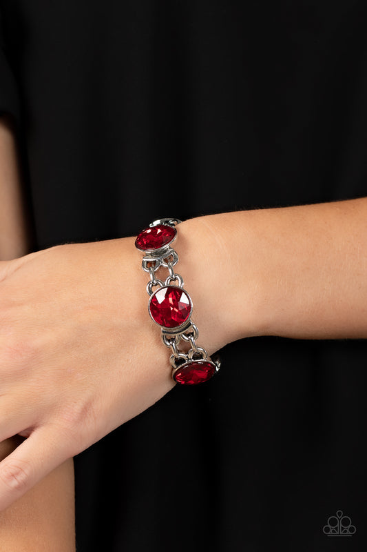 Devoted to Drama Red Bracelet - Paparazzi Accessories  Featuring edgy chain-like fittings, a sparkly series of oversized red rhinestones are threaded along stretchy bands around the wrist for a dramatic pop of glitz.  Sold as one individual bracelet.