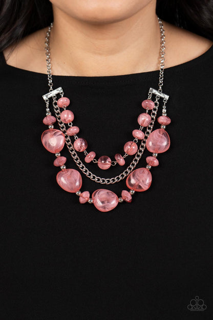 Oceanside Service Pink Necklace - Paparazzi Accessories  A single silver chain separates two mismatched rows of oversized and cloudy glass-like pink beads. The colorful rows are held in place with textured silver fittings, creating an ethereal pop of color below the collar. Features an adjustable clasp closure.  Sold as one individual necklace. Includes one pair of matching earrings.