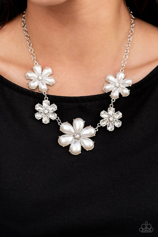 Fiercely Flowering White Pearl Necklace - Paparazzi Accessories  Featuring glassy white rhinestone centers, bubbly pearl petaled flowers gradually increase in size as they alternate with white rhinestone petaled flowers below the collar for a fierce floral fashion. Features an adjustable clasp closure.  Sold as one individual necklace. Includes one pair of matching earrings.