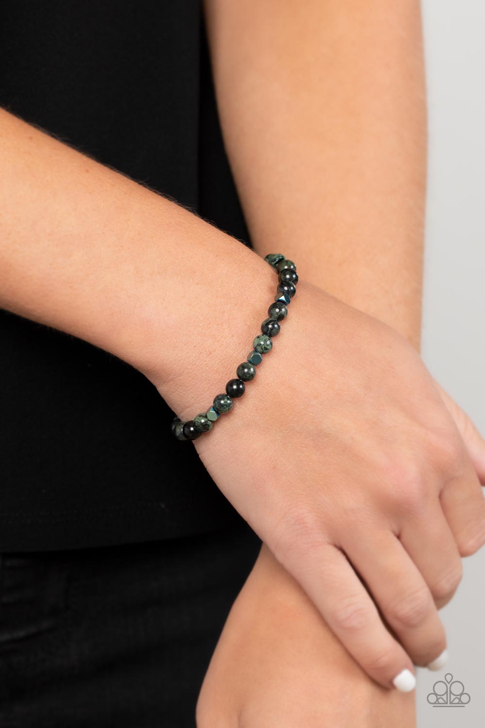 Interstellar Solitude - Green A dainty collection of speckled green stone beads and faceted metallic cube beads are threaded along a stretchy band around the wrist for an earthy flair.  Sold as one individual bracelet.  SKU: P9SE-URGR-176XX