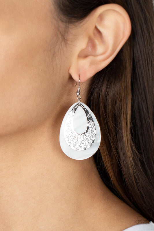 Bountiful Beaches White Earring - Paparazzi Accessories  A hammered silver teardrop that is stenciled in an abstract pattern delicately overlaps with a white shell-like teardrop, creating a whimsical lure as it swings from the ear. Earring attaches to a standard fishhook fitting.  Sold as one pair of earrings.