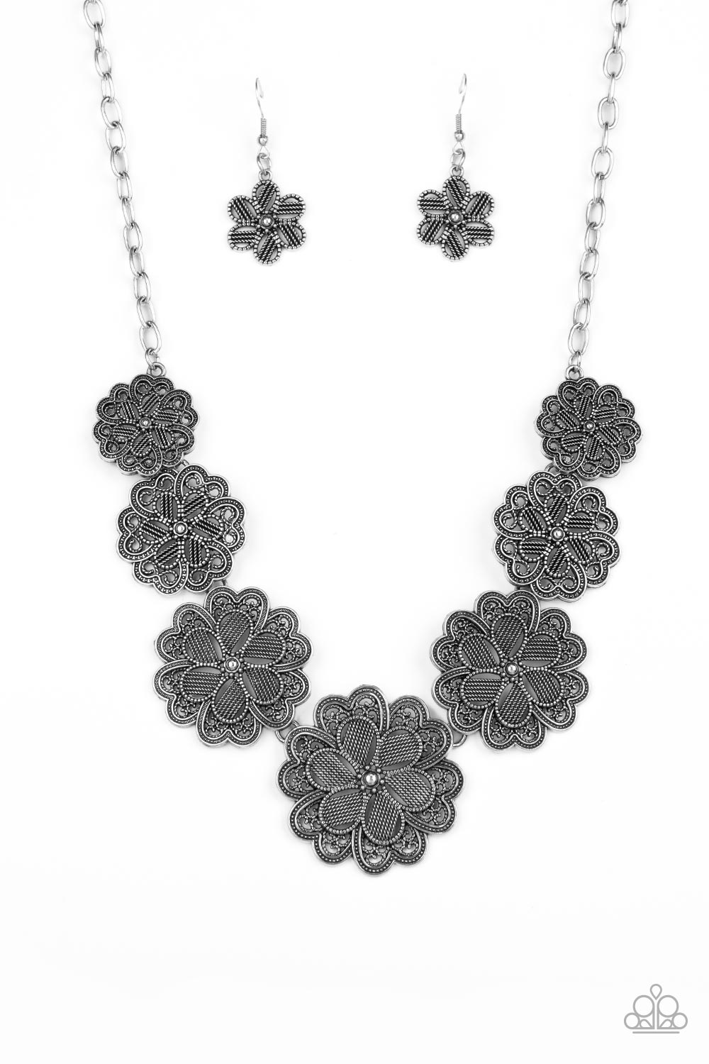 Basketful of Blossoms Silver Necklace - Paparazzi Accessories  Featuring metallic wicker-like patterns, stacks of teardrop and heart shaped filigree-filled silver petals delicately link into a decorative row of flowers. The floral frames gradually increase in size as they move towards the center, creating a vintage inspired display below the collar. Features an adjustable clasp closure.  Sold as one individual necklace. Includes one pair of matching earrings.