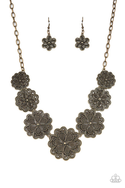 Basketful of Blossoms Brass Necklace - Paparazzi Accessories  Featuring metallic wicker-like patterns, stacks of teardrop and heart shaped filigree-filled brass petals delicately link into a decorative row of flowers. The floral frames gradually increase in size as they move towards the center, creating a vintage inspired display below the collar. Features an adjustable clasp closure.  Sold as one individual necklace. Includes one pair of matching earrings.