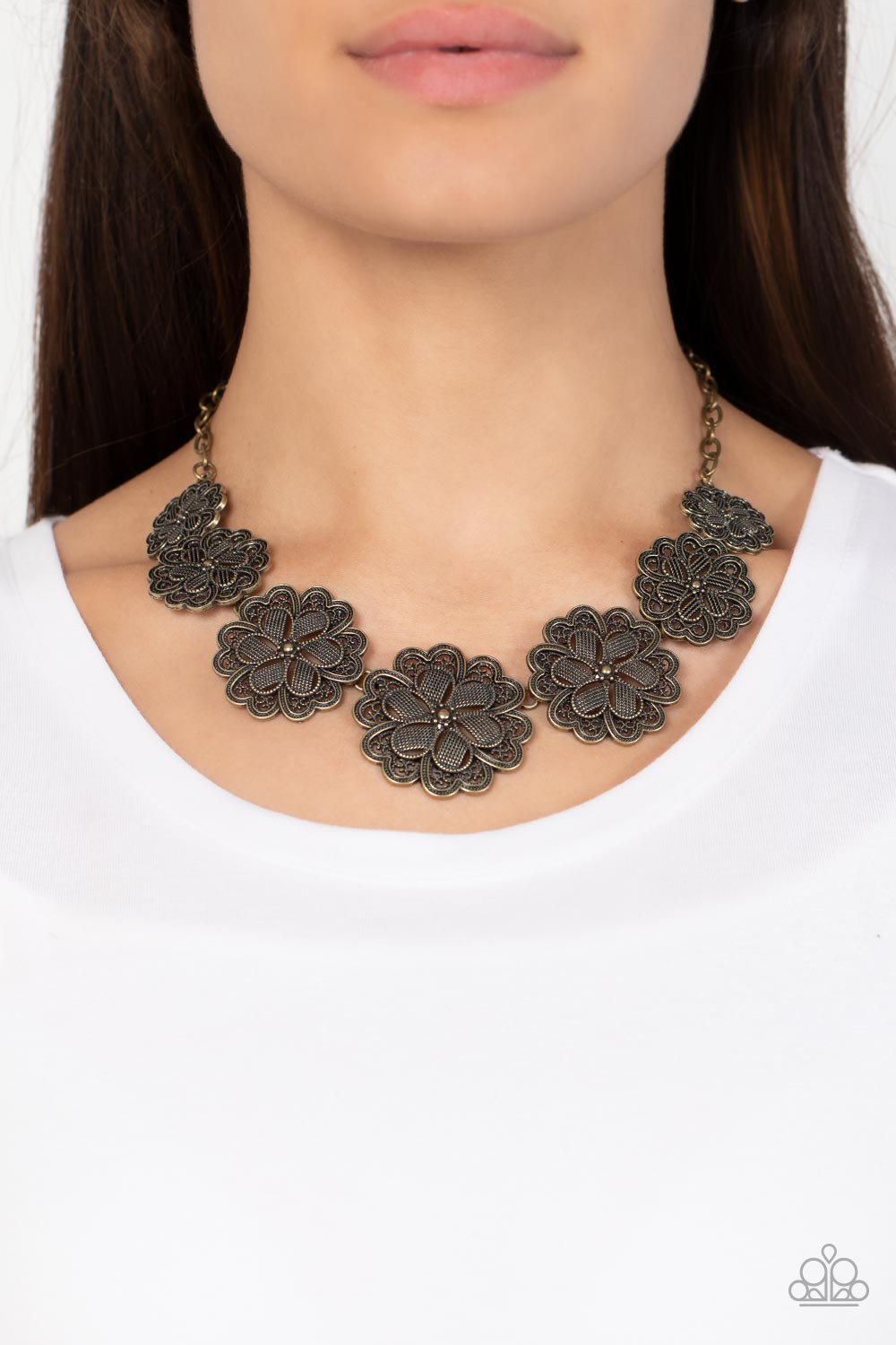 Basketful of Blossoms Brass Necklace - Paparazzi Accessories  Featuring metallic wicker-like patterns, stacks of teardrop and heart shaped filigree-filled brass petals delicately link into a decorative row of flowers. The floral frames gradually increase in size as they move towards the center, creating a vintage inspired display below the collar. Features an adjustable clasp closure.  Sold as one individual necklace. Includes one pair of matching earrings.