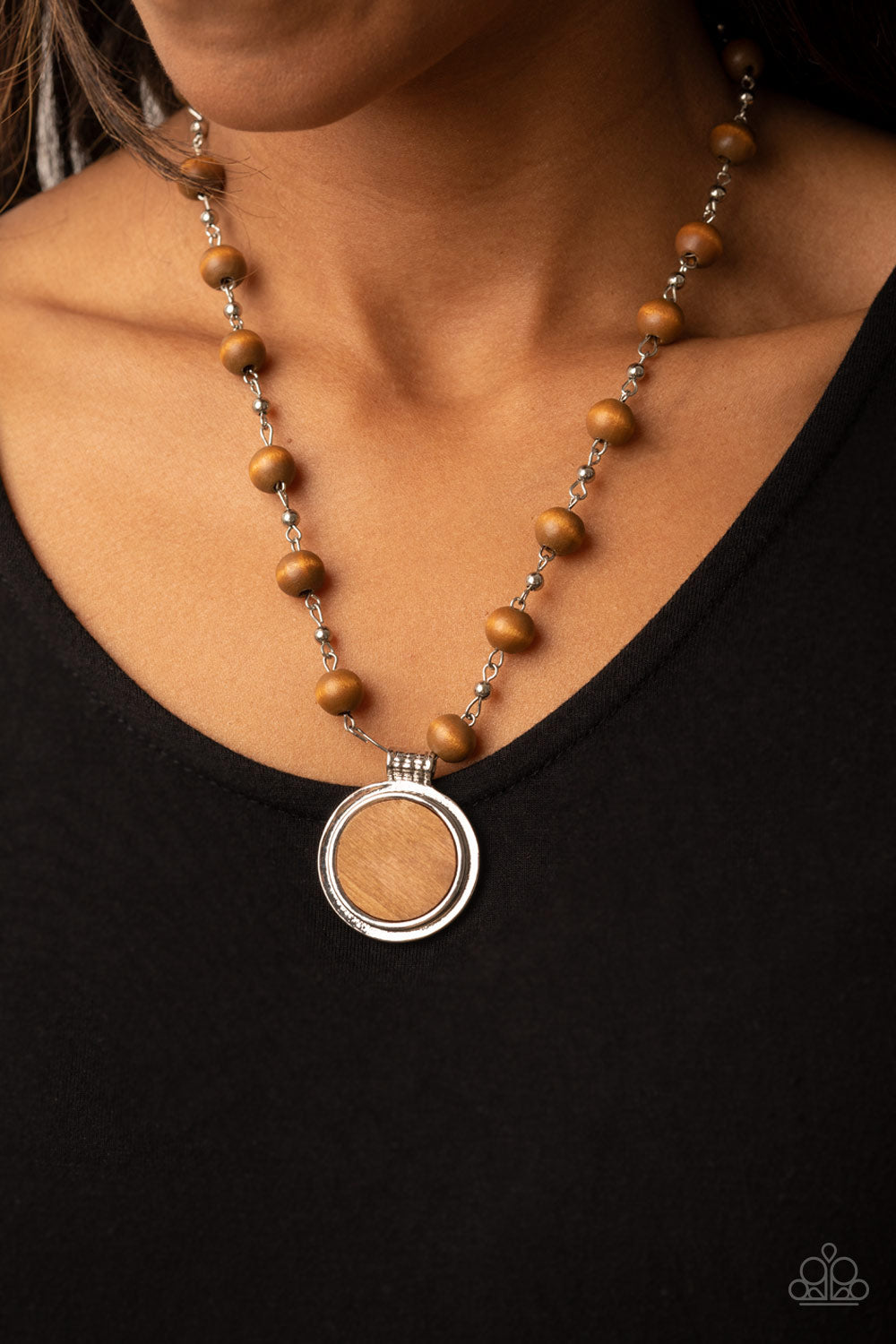 Soulful Sunrise Brown Necklace - Paparazzi Accessories  Infused with dainty silver chains, a collection of brown wooden beads link into an earthy chain below the collar. Featuring a textured silver fitting, a flat wooden disc is pressed into a silver frame, resulting in a naturally refined pendant. Features an adjustable clasp closure.  Sold as one individual necklace. Includes one pair of matching earrings.