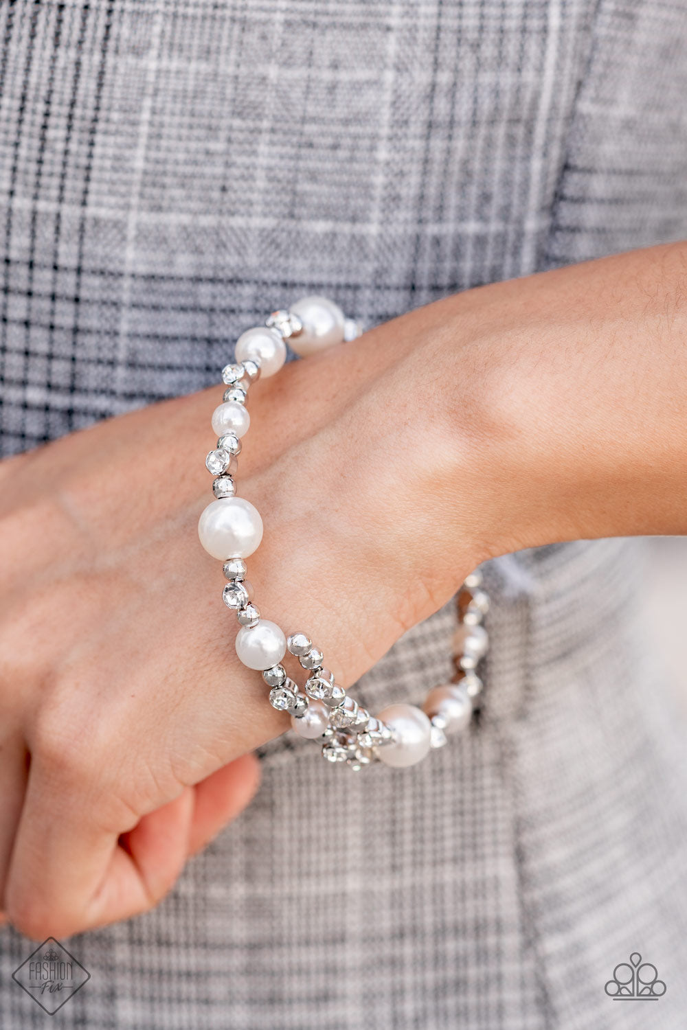 Chicly Celebrity White Pearl Bracelet - Paparazzi Accessories  Luscious bubbly pearls and brilliant white rhinestones are accented with shiny silver beads threaded along a single wire to create a chicly glamorous infinity wrap bracelet.  All Paparazzi Accessories are lead free and nickel free!  Sold as one individual bracelet.