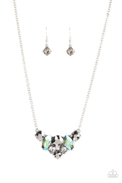 Lavishly Loaded Silver Necklace - Paparazzi Accessories  A smoldering collection of smoky, iridescent, and hematite gems of various cuts coalesces into a lavish frame at the bottom of a classic silver chain, resulting in a glamorous finish below the collar.  Sold as one individual necklace. Includes one pair of matching earrings.