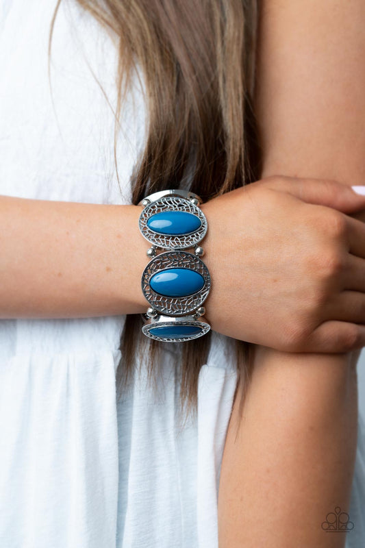 Eastern Escapade Blue Bracelet - Paparazzi Accessories  Bordered in airy stenciled frames, bubbly Mykonos Blue beaded silver frames join pairs of silver beads along stretchy bands along the wrist for a whimsical pop of color.  Sold as one individual bracelet.