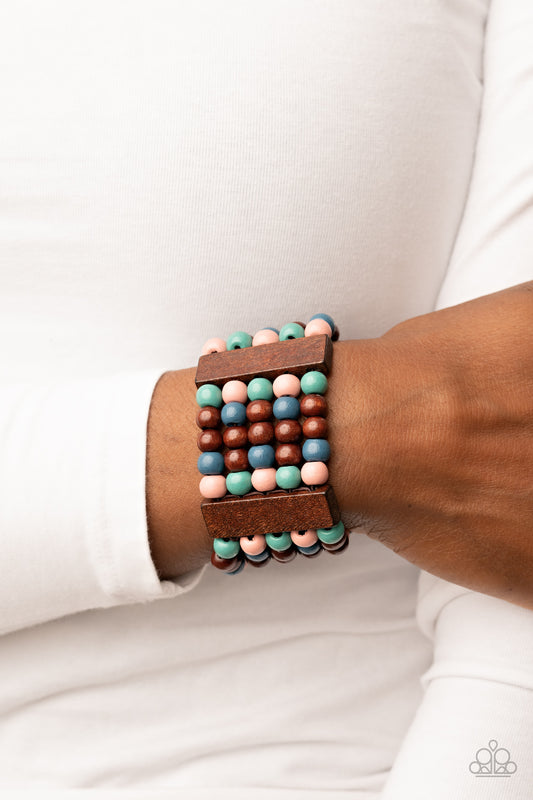Island Soul Multi Wood Bracelet - Paparazzi Accessories  Colorful layers of blue, pink, brown, and turquoise wooden beads are threaded along stretchy bands between brown wooden bars creating stacks of subtle bliss around the wrist.  Sold as one individual bracelet.