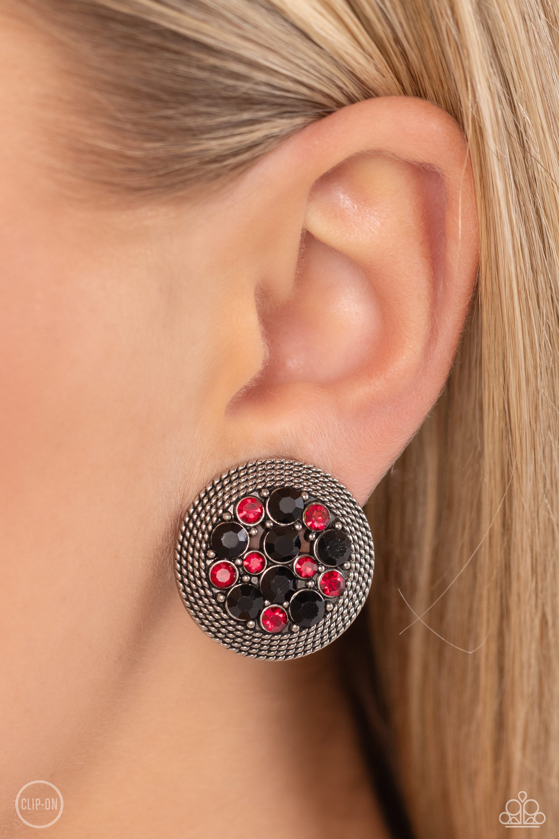 Stellar Status Multi Clip-On Earring - Paparazzi Accessories  A glitzy collection of red and black rhinestones are encircled with a silver rope-like border, resulting in a smoldering centerpiece. Earring attaches to a standard clip-on fitting.  Sold as one pair of clip-on earrings.  P5CO-MTXX-008XX