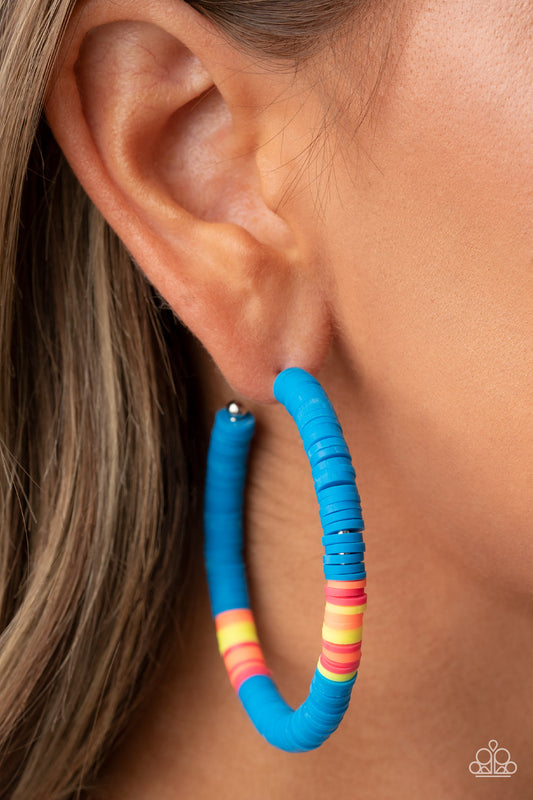 Colorfully Contagious Blue Hoop Earring - Paparazzi Accessories  Rubbery blue, pink, yellow, and orange bands are threaded along an oversized silver hoop, creating a courageous pop of color. Earring attaches to a standard post fitting. Hoop measures approximately 2 1/4" in diameter.  Sold as one pair of hoop earrings.