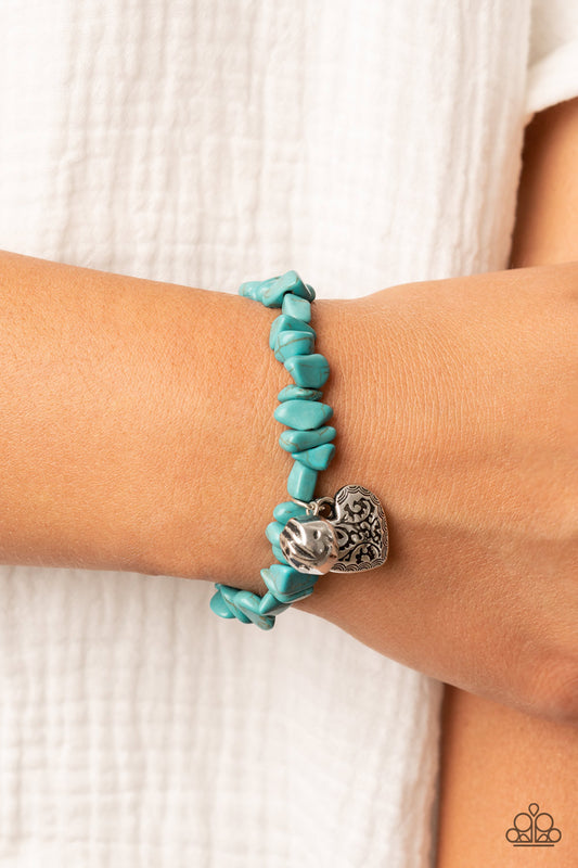 Love You to Pieces Turquoise Bracelet - Paparazzi Accessories  Infused with a hammered silver bead and a decorative silver heart charm, an earthy collection of turquoise pebbles are threaded along a stretchy band around the wrist for a whimsical fashion.  Sold as one individual bracelet.