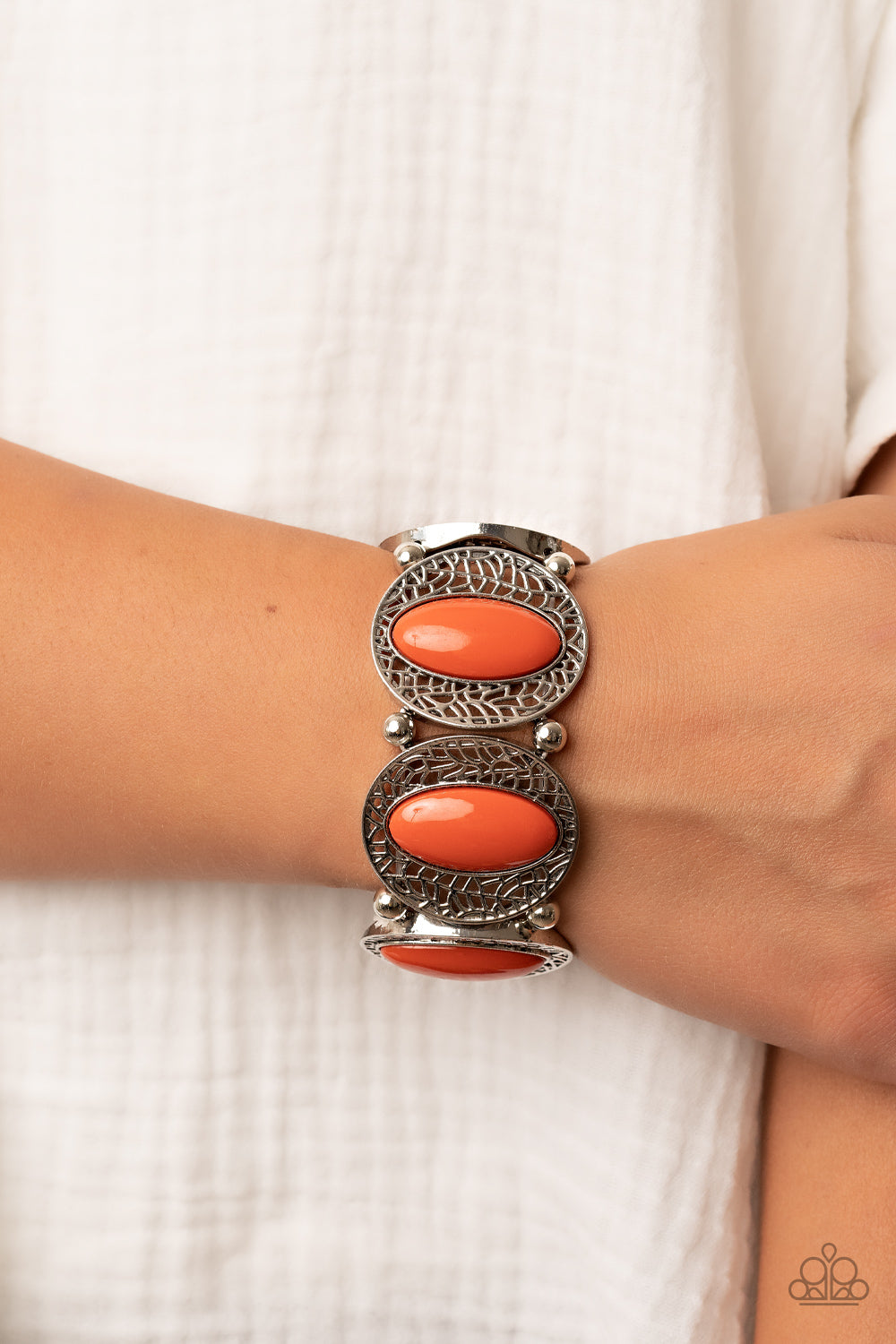 Eastern Escapade Orange Bracelet - Paparazzi Accessories  Bordered in airy stenciled frames, burnt orange beaded silver frames join pairs of silver beads along stretchy bands along the wrist for a seasonal pop of color.  Sold as one individual bracelet.