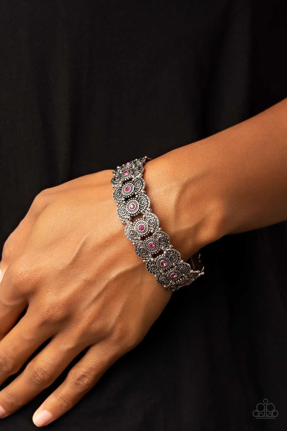 Rapturous Romance Pink Bracelet - Paparazzi Accessories  Dotted with sparkly pink rhinestones, pairs of studded and heart embossed patterned silver frames are threaded along stretchy bands around the wrist for a romantic fashion.  Sold as one individual bracelet.