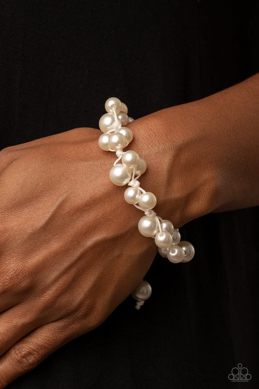 Vintage Versatility - White Item #P9WH-WTXX-230XX Bubbly clusters of white pearls are decoratively knotted around the wrist, adding a timeless twist to the elegant centerpiece. Features an adjustable sliding knot closure.  Sold as one individual bracelet.