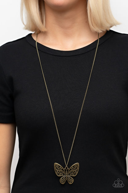 Butterfly Boutique Brass Necklace - Paparazzi Accessories  Filled with frilly filigree details, a rustic brass butterfly flutters from the bottom of an extended brass chain for a whimsical fashion. Features an adjustable clasp closure.  Sold as one individual necklace. Includes one pair of matching earrings.