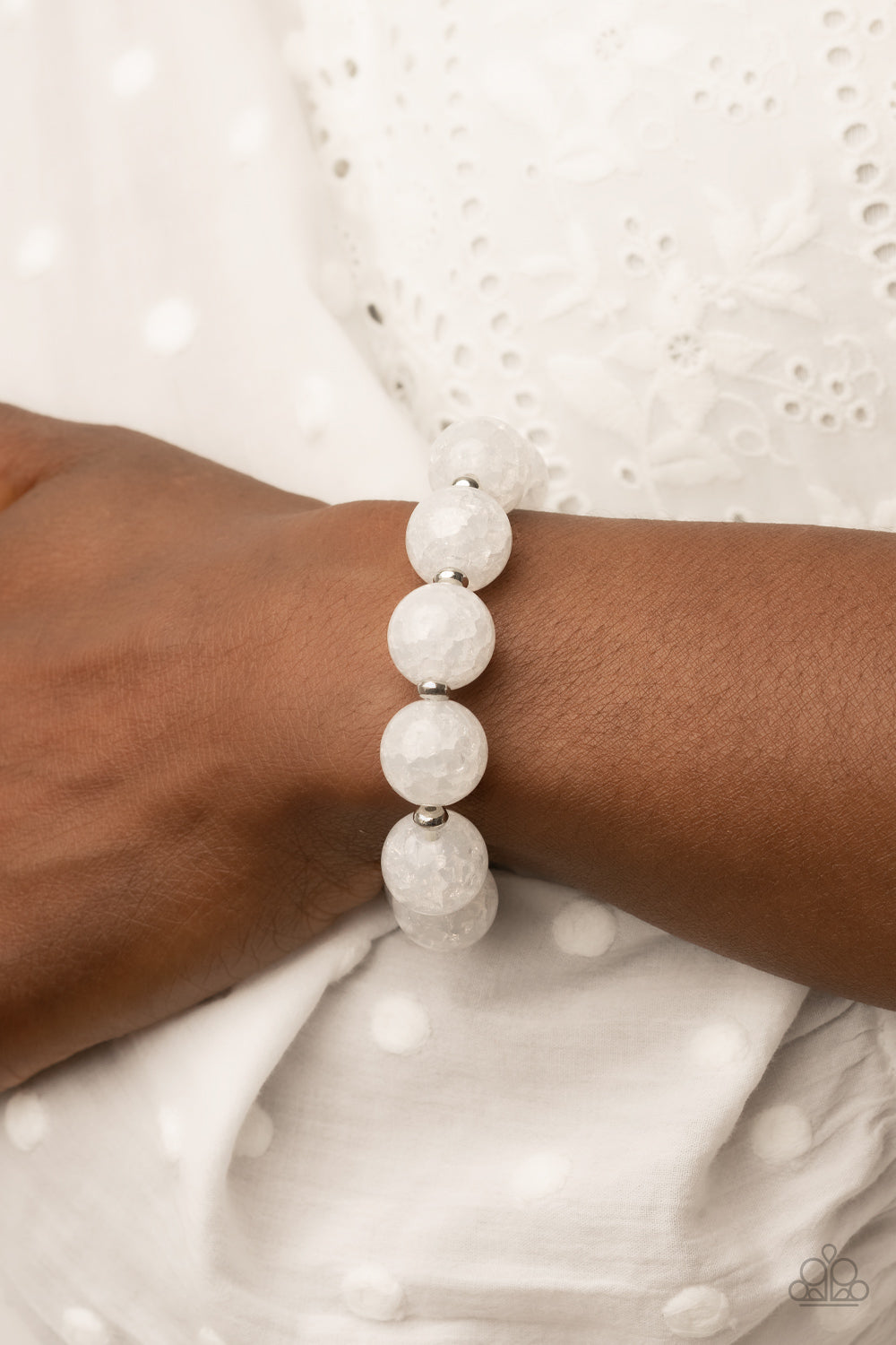 Arctic Affluence White Bracelet - Paparazzi Accessories  Infused with dainty silver accents, an oversized collection of crackly white glass-like beads are threaded along stretchy bands around the wrist for an icy look.  Sold as one individual bracelet.