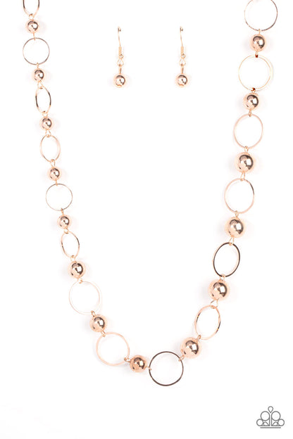 Metro Milestone Rose Gold Necklace - Paparazzi Accessories  Gradually increasing in size, a glistening collection of rose gold beads and rose gold hoops alternate across the chest for a classic metallic fashion. Features an adjustable clasp closure.  Sold as one individual necklace. Includes one pair of matching earrings.