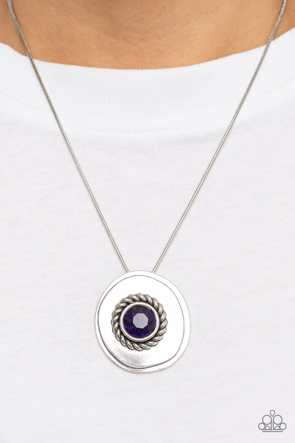 Make Me a MEDALLION-aire - Purple Item #P2RE-PRXX-261XX An oversized purple rhinestone adorns the textured center of an asymmetrical silver disc, creating an edgy medallion at the bottom of a rounded silver snake chain below the collar. Features an adjustable clasp closure.  Sold as one individual necklace. Includes one pair of matching earrings.