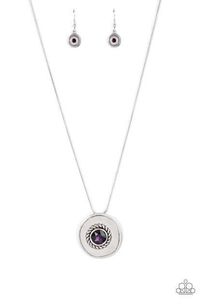 Make Me a MEDALLION-aire - Purple Item #P2RE-PRXX-261XX An oversized purple rhinestone adorns the textured center of an asymmetrical silver disc, creating an edgy medallion at the bottom of a rounded silver snake chain below the collar. Features an adjustable clasp closure.  Sold as one individual necklace. Includes one pair of matching earrings.