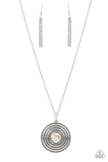 Targeted Tranquility - White Item #P2SE-WTXX-275XX Flecked in iridescent shell-like accents, a studded white frame adorns the center of an oversized silver pendant rippling with concentric circles at the bottom of an extended silver chain for a dizzying pop of color. Features an adjustable clasp closure.  Sold as one individual necklace. Includes one pair of matching earrings.