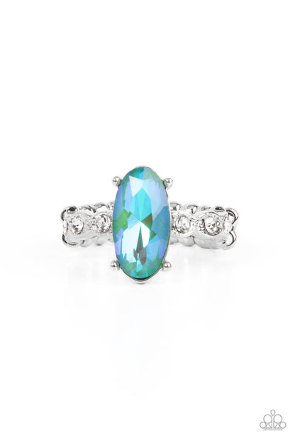 Stellar Sensation Green Ring - Paparazzi Accessories  Featuring a blue UV finish, an iridescent green oval rhinestone is nestled inside a pronged silver frame atop a dainty band of white rhinestones for a stellar fashion. Features a dainty stretchy band for a flexible fit.  Sold as one individual ring.