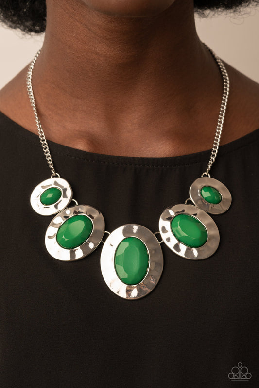 Rivera Rendezvous Green Necklace - Paparazzi Accessories  Gradually increasing in size, hammered silver oval frames are dotted with opalescent Leprechaun beads as they delicately link below the collar for a refreshing pop of color. Features an adjustable clasp closure.  Sold as one individual necklace. Includes one pair of matching earrings.