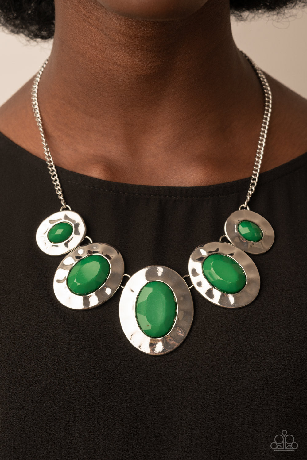 Rivera Rendezvous Green Necklace - Paparazzi Accessories  Gradually increasing in size, hammered silver oval frames are dotted with opalescent Leprechaun beads as they delicately link below the collar for a refreshing pop of color. Features an adjustable clasp closure.  Sold as one individual necklace. Includes one pair of matching earrings.