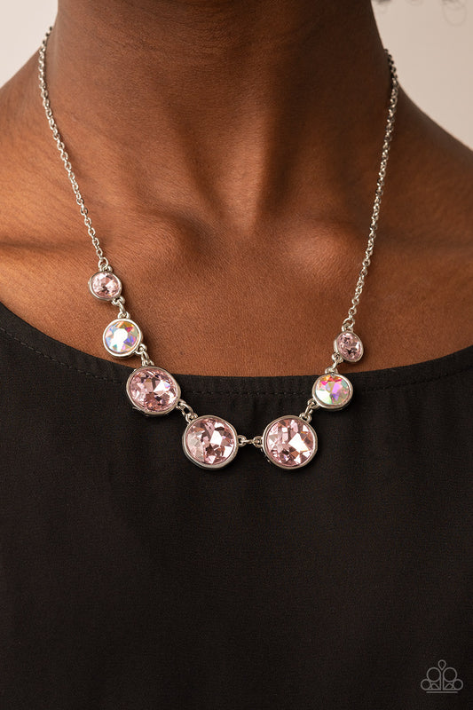 Pampered Powerhouse Pink Necklace - Paparazzi Accessories  Encased in shiny silver frames, a glitzy collection of pink and iridescent gems gradually increase in size as they link below the collar for a flawless finish. Features an adjustable clasp closure.  Sold as one individual necklace. Includes one pair of matching earrings.
