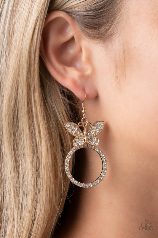 Paradise Found Gold Butterfly Earring - Paparazzi Accessories  A white rhinestone encrusted gold butterfly flutters atop a gold ring dotted in matching white rhinestones, resulting in a dazzling statement piece. Earring attaches to a standard fishhook fitting.  Sold as one pair of earrings.