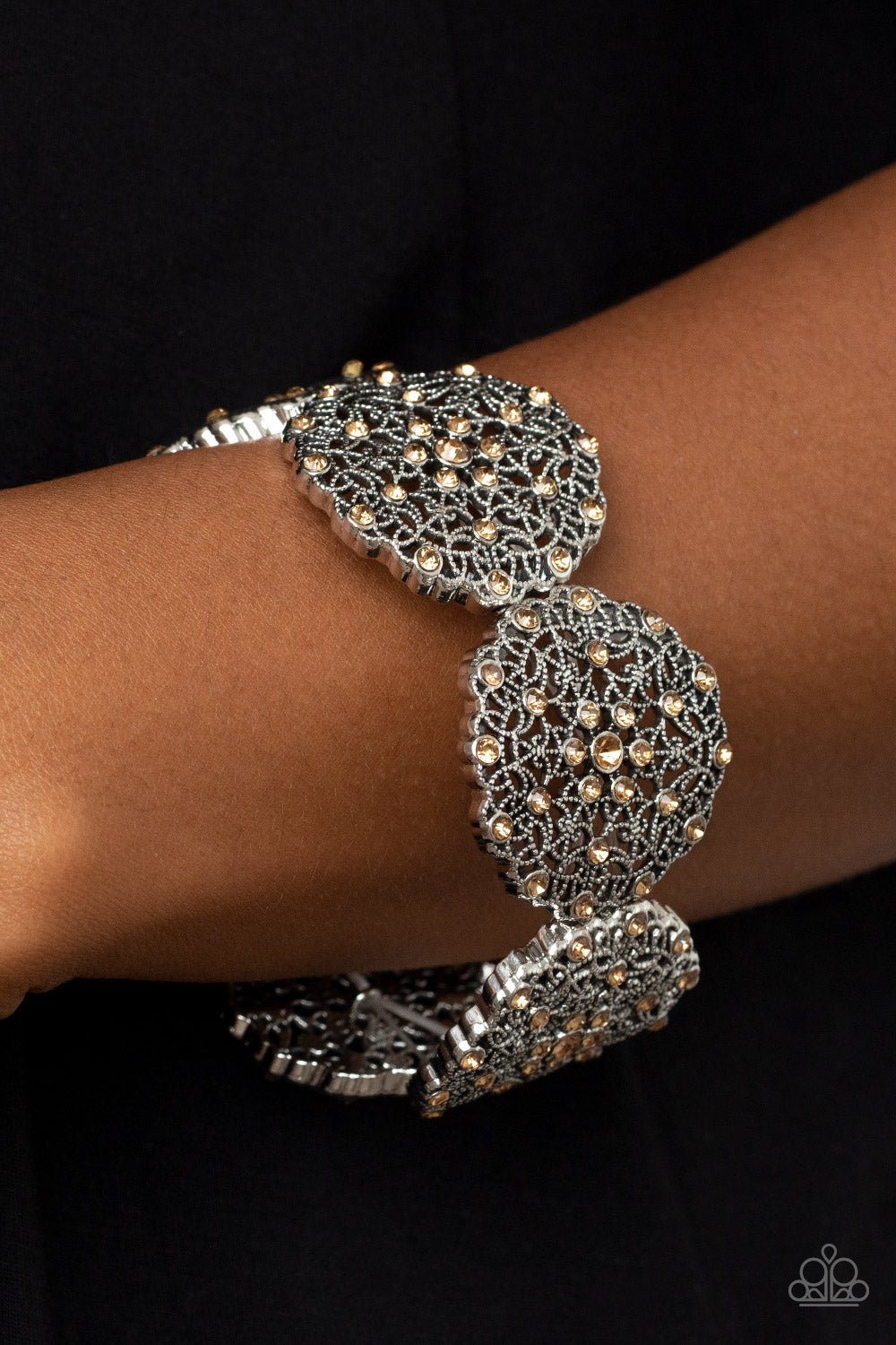 All in the Details Brown Bracelet - Paparazzi Accessories  Dotted with golden topaz rhinestones, studded silver frames are filled with mandala-like filigree details and threaded along stretchy bands around the wrist for a glitzy pop of color.  Sold as one individual bracelet.