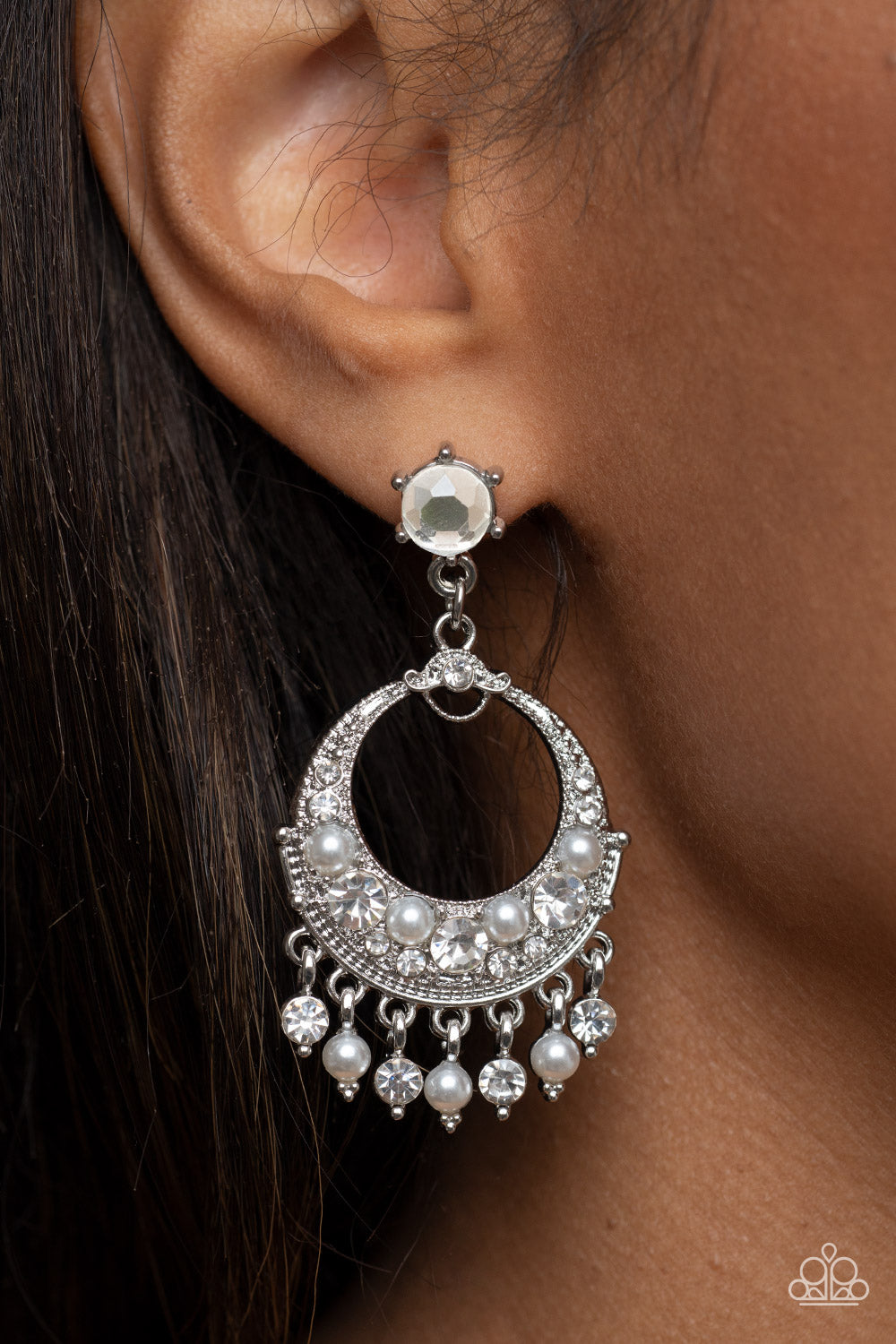 Marrakesh Request White Post Earring - Paparazzi Accessories  White pearl and white rhinestone dotted frames dance from the bottom of an ornate silver hoop encrusted in matching bubbly accents, resulting in a timeless fringe at the bottom of a solitaire white rhinestone. Earring attaches to a standard fishhook fitting.  Sold as one pair of post earrings.
