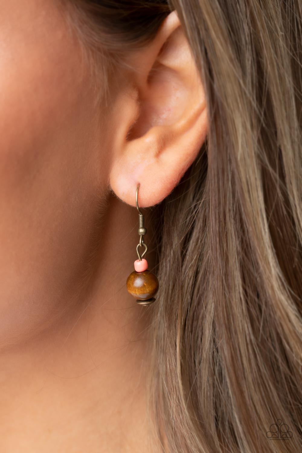 Knotted Keepsake Orange Necklace - Paparazzi Accessories  An earthy assortment of orange and coral seed beads, rustic brass discs, and wooden accents glide along lengthy strands of brown cording that knot around a hammered brass disc. Tassels of matching beads, a white shell-like accent, floral silver bead, and brass leaf charm dance from the bottom, adding playful movement to the free-spirited display. Features an adjustable clasp closure. Includes one pair of matching earrings.
