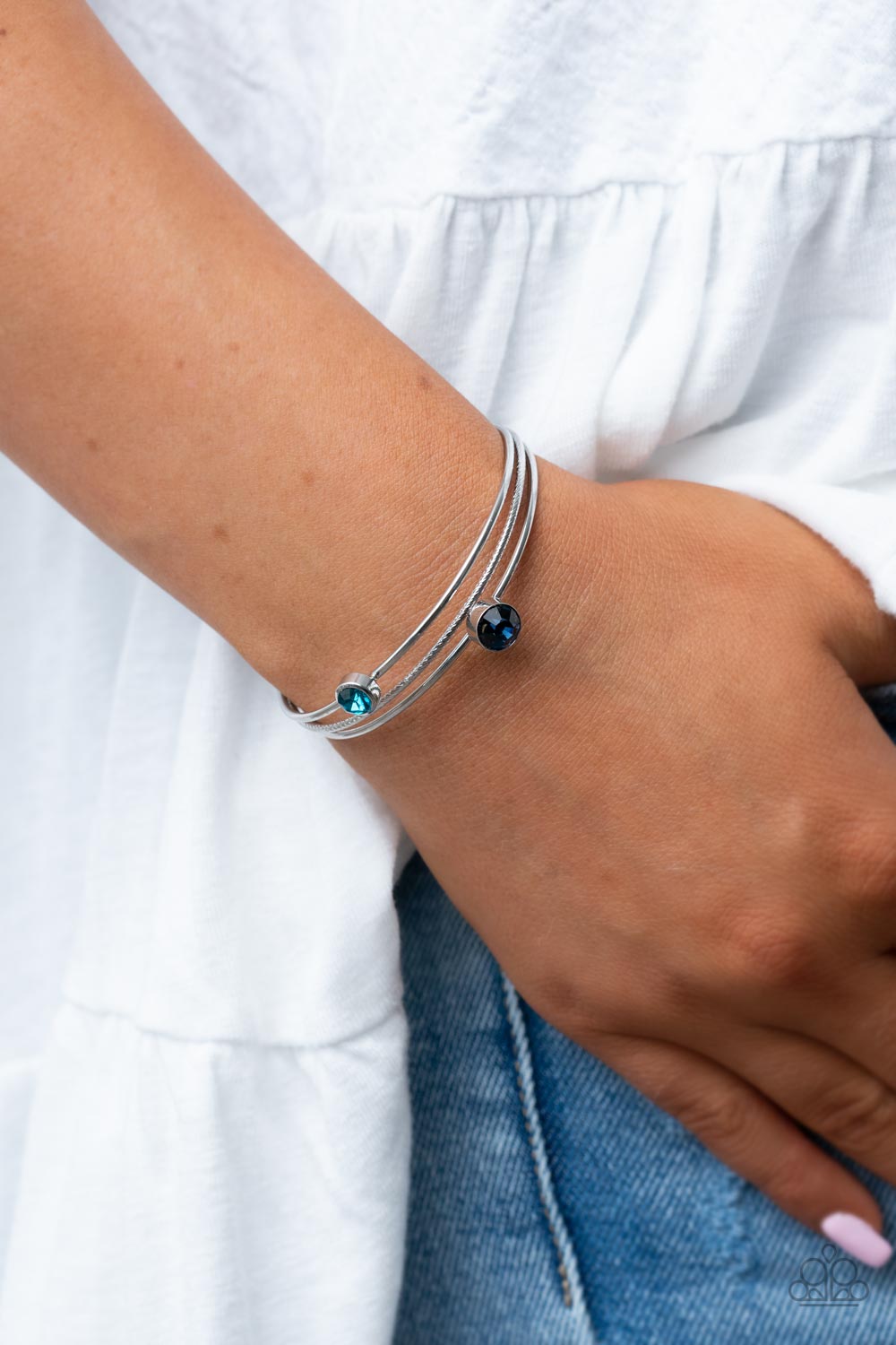Your PALACE or Mine? - Blue Item #P9RE-BLXX-205XX A pair of dark and classic blue rhinestones sporadically adorn a layered silver cuff, creating a dainty dazzle around the wrist.  Sold as one individual bracelet.