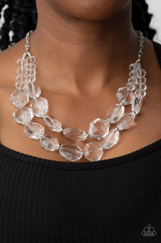 Icy Illumination White Necklace - Paparazzi Accessories  Separated by dainty silver beads, an icy collection of oversized and faceted white gems are threaded along invisible wires below the collar, resulting in prismatic layers. Features an adjustable clasp closure.  Sold as one individual necklace. Includes one pair of matching earrings.