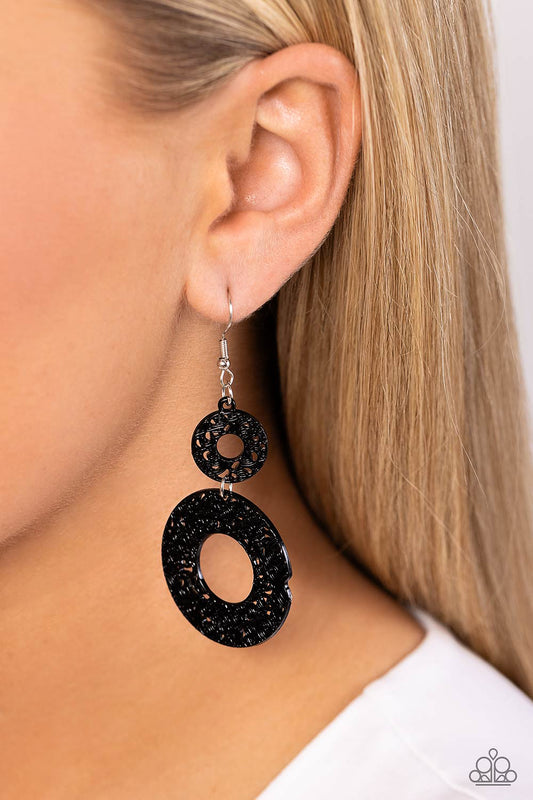 Cabo Courtyard Black Earring - Paparazzi Accessories  Painted in a distressed black finish, vine-like silver filigree blooms into two thick flat hoops that delicately link into a whimsical lure. Earring attaches to a standard fishhook fitting.  Sold as one pair of earrings.  Sku:  P5WH-BKXX-220XX