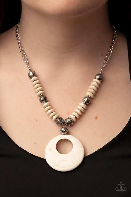 Oasis Goddess White Necklace - Paparazzi Accessories  Infused with dainty silver accents, mismatched silver beads and white stone discs are threaded along an invisible wire below the collar. An oversized white stone pendant swings from the center of the earthy strand, creating a natural pop of seasonal inspiration. Features an adjustable clasp closure.  Sold as one individual necklace. Includes one pair of matching earrings.