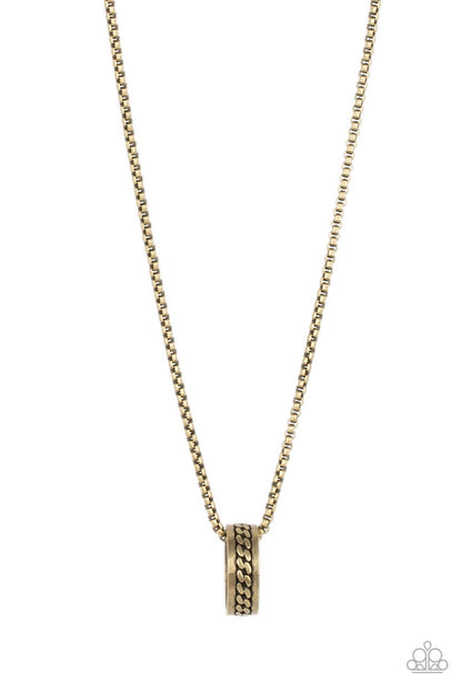 Emotion Potion Brass Urban Necklace - Paparazzi Accessories  Embossed in a band of zigzagging texture, an antiqued brass ring glides along a strand of brass box chain across the chest in a rustic fashion. Features an adjustable clasp closure.  Sold as one individual necklace.