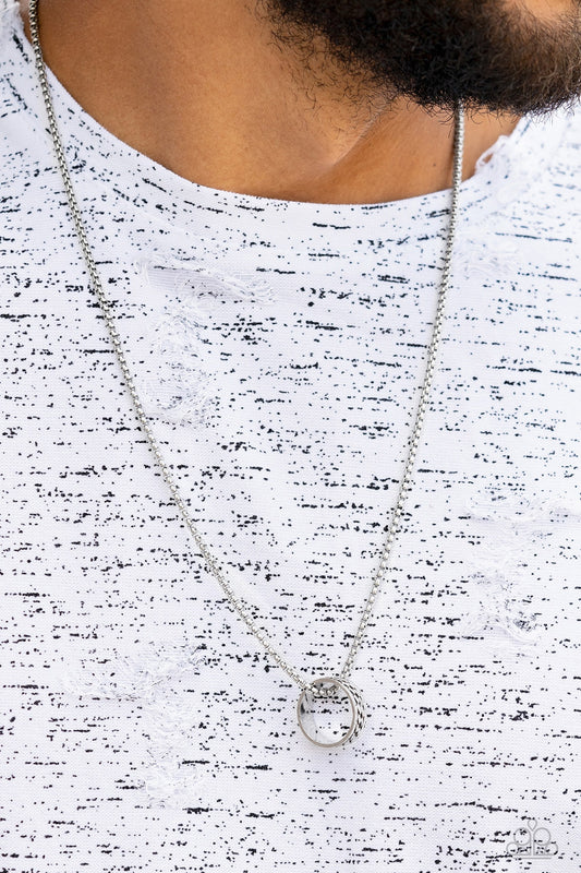 Emotion Potion Silver Necklace - Paparazzi Accessories  Embossed in a band of zigzagging texture, an antiqued silver ring glides along a strand of silver box chain across the chest in a rustic fashion. Features an adjustable clasp closure.  Sold as one individual necklace.