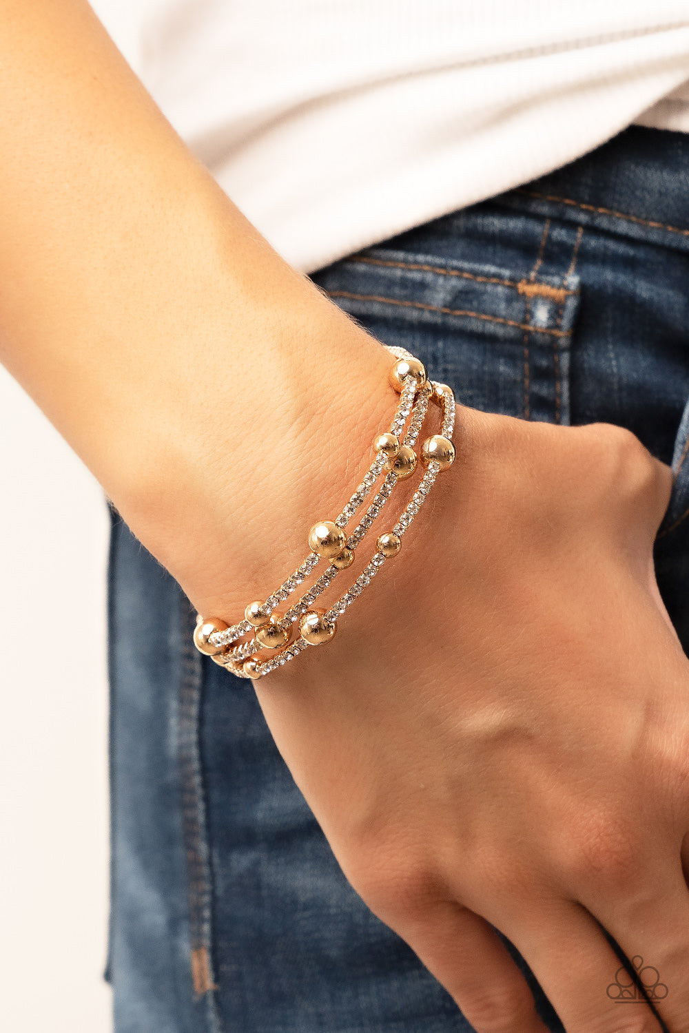 Spontaneous Shimmer Gold Bracelet - Paparazzi Accessories  Spontaneously interrupted by glistening gold beads, a sparkly strand of white rhinestones coils around the wrist, resulting in an irresistible infinity wrap bracelet.  Sold as one individual bracelet.