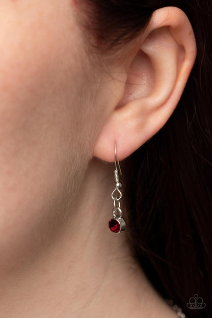 Sonata Swing - Red Item #P2RE-RDXX-234XX Dainty white rhinestones are sprinkled across silver vine-like filigree that whirls around an oval red gem center inside of a studded silver frame, resulting in a whimsical pendant at the bottom of a silver chain. Features an adjustable clasp closure.  Sold as one individual necklace. Includes one pair of matching earrings.