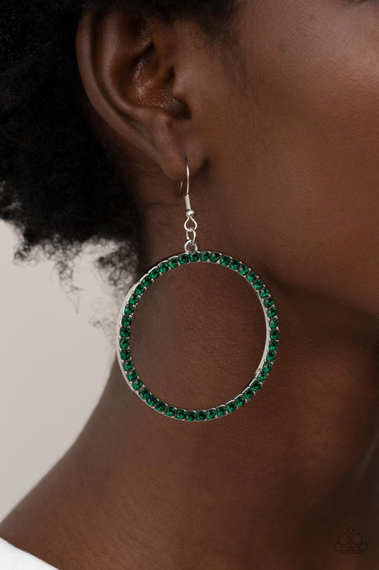 Head-Turning Halo Green Earring - Paparazzi Accessories  The front of an oversized silver ring is encrusted in glitzy Leprechaun rhinestones, resulting in a head-turning hoop. Earring attaches to a standard fishhook fitting.  Sold as one pair of earrings.