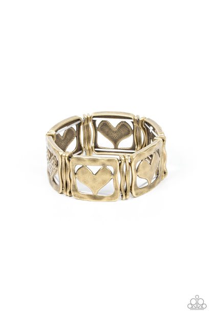 Legendary Lovers Brass Bracelet - Paparazzi Accessories  Encased in hammered brass frames, hammered brass hearts and brass hearts featuring a hammered dotted motif join pairs of wavy brass frames along stretchy bands around the wrist for a romantic flair.  Sold as one individual bracelet.