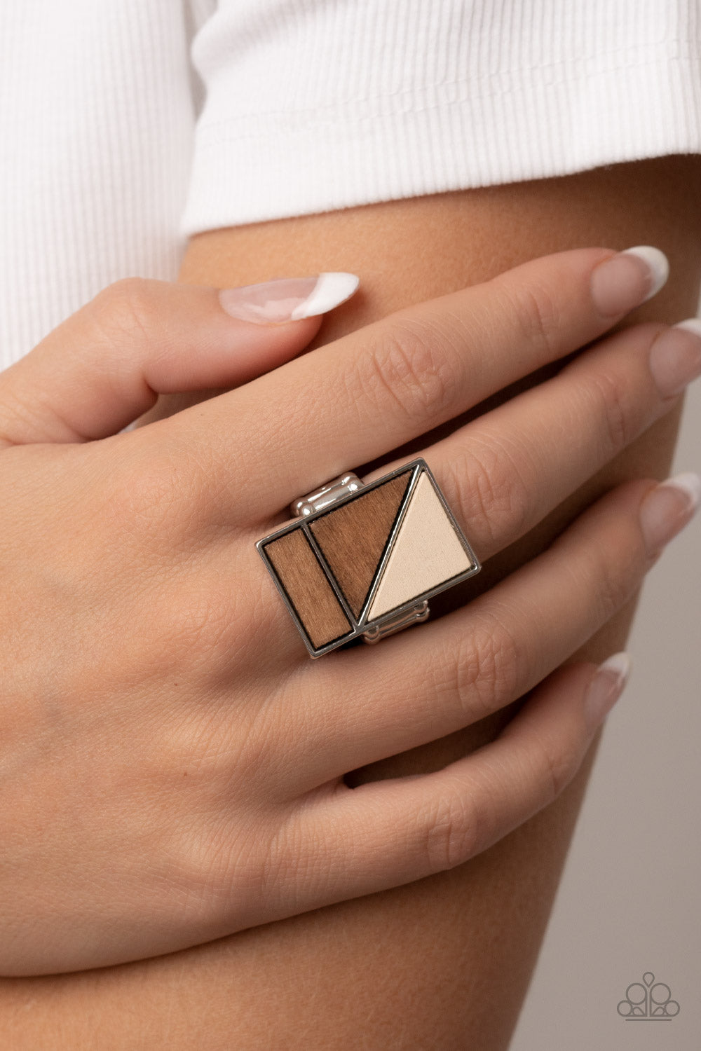 Happily EVERGREEN After Brown Ring - Paparazzi Accessories  Featuring natural white and brown finishes, triangular and rectangular wooden frames stack into a geometrically appealing centerpiece atop the finger. Features a stretchy band for a flexible fit.  Featured inside The Preview at GLOW!  Sold as one individual ring.