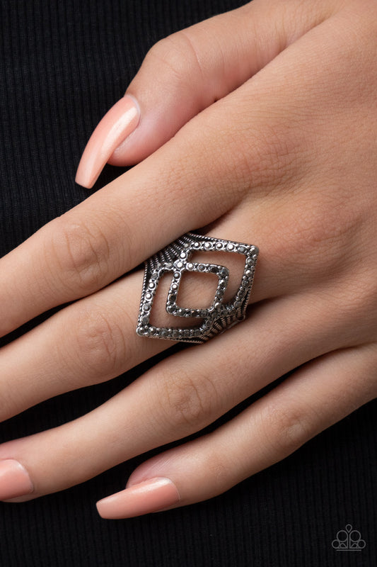 Diamond Duet Silver Ring - Paparazzi Accessories  A pair of hematite encrusted diamond shaped frames stacks atop studded silver fittings, culminating into an edgy sparkle. Features a stretchy band for a flexible fit.  Sold as one individual ring.