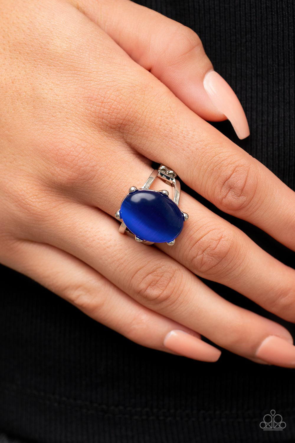 Enchantingly Everglades Blue Ring - Paparazzi Accessories  An oval blue cat's eye gemstone sits atop a pronged silver frame along two layered silver bands, resulting in an enchanting centerpiece atop the finger. Features a stretchy band for a flexible fit.  Sold as one individual ring.